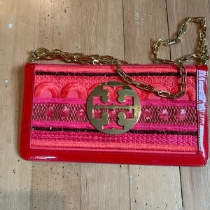 Tory Burch gold clutch strap purse.